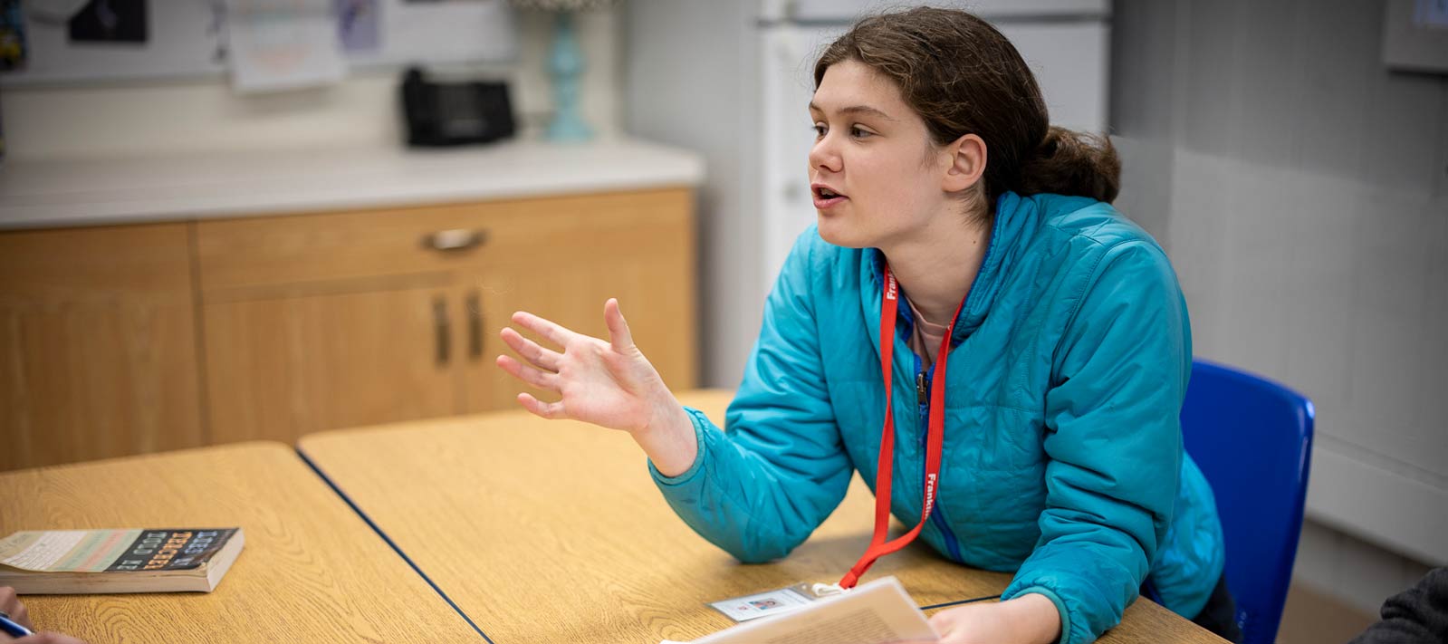 Transforming lives. Girl leading classroom discussion